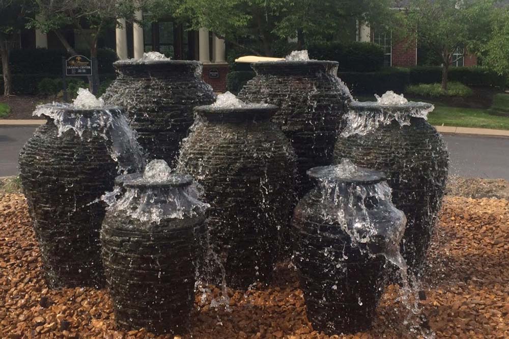 A cluster of ceramic vase fountains in a Nashville landscape.