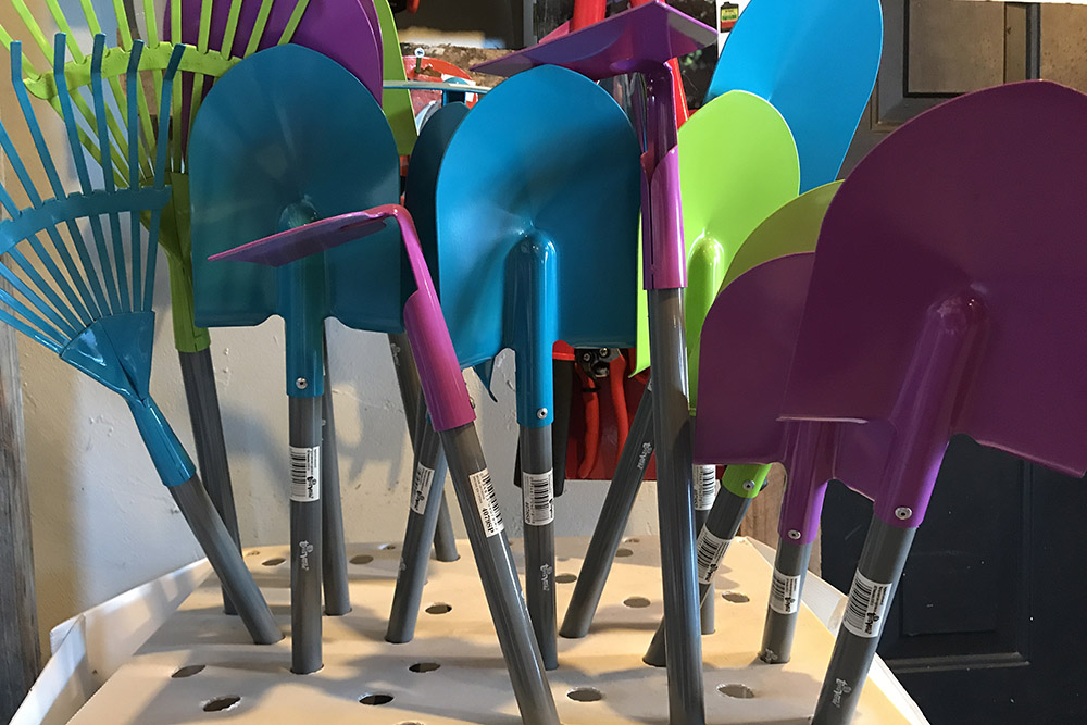 Colorful kids' garden tools in a stand