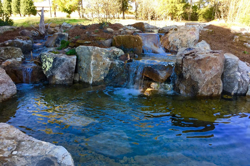 A multi-drop JVI waterfall with feature lighting on the rocks.