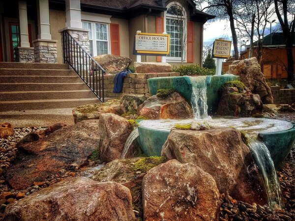 Commercial entry with a layered rock waterfall feature